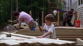 Movie still from “You Can Count on Me” (2000), directed by Kenneth Lonergan – A man and a boy working on a wooden structure; Medium shot, Over the shoulder angle