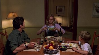 Movie still from “You Can Count on Me” (2000), directed by Kenneth Lonergan – A group of people sitting around a table with food on it; Medium shot, High angle