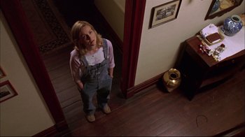 Movie still from “You Can Count on Me” (2000), directed by Kenneth Lonergan – A young girl standing in a doorway looking up at the camera; Medium shot, Low angle