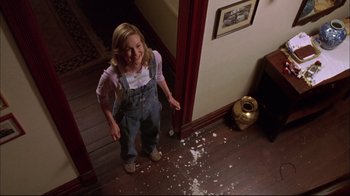 Movie still from “You Can Count on Me” (2000), directed by Kenneth Lonergan – A woman standing in front of a mess of paper on the floor; Medium shot, High angle