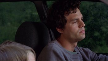 Movie still from “You Can Count on Me” (2000), directed by Kenneth Lonergan – A man sitting in the back seat of a car with his eyes closed; Close Up shot, Over the shoulder angle