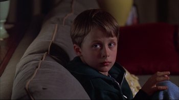 Movie still from “You Can Count on Me” (2000), directed by Kenneth Lonergan – A young boy sitting on a couch in the dark; Close Up shot, Low angle