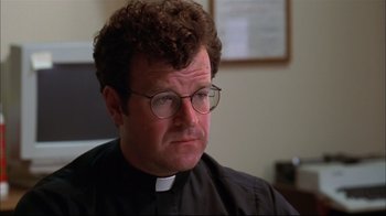 Movie still from “You Can Count on Me” (2000), directed by Kenneth Lonergan – A man wearing glasses and a priest outfit; Close Up shot, Low angle