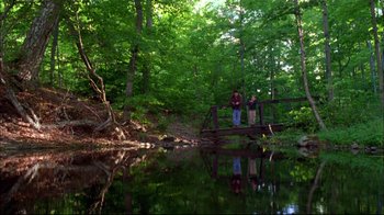 Movie still from “You Can Count on Me” (2000), directed by Kenneth Lonergan – Two people are standing on a bridge over a river; Extreme Wide shot, High angle