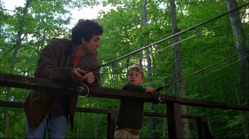 Movie still from “You Can Count on Me” (2000), directed by Kenneth Lonergan – A man and a boy fishing on a wooden bridge; Medium shot, Low angle