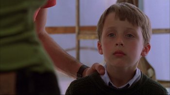 Movie still from “You Can Count on Me” (2000), directed by Kenneth Lonergan – A young boy getting his hair cut by an adult; Close Up shot, Over the shoulder angle