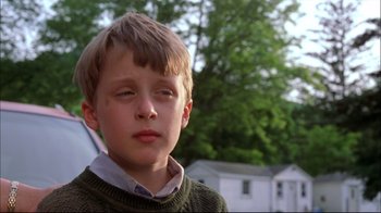 Movie still from “You Can Count on Me” (2000), directed by Kenneth Lonergan – A young boy in a green sweater looks at the camera; Close Up shot, Low angle