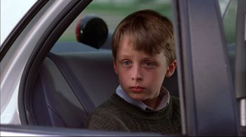 Movie still from “You Can Count on Me” (2000), directed by Kenneth Lonergan – A boy sitting in the back seat of a car; Close Up shot, Low angle