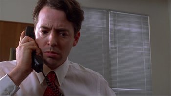 Movie still from “You Can Count on Me” (2000), directed by Kenneth Lonergan – A person wearing a suit and tie; Close Up shot, Low angle