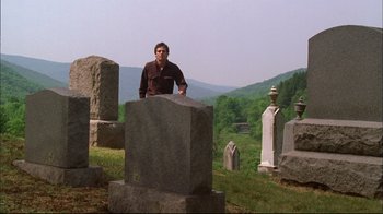 Movie still from “You Can Count on Me” (2000), directed by Kenneth Lonergan – A man standing on top of a grave in a cemetery; Wide shot, Low angle