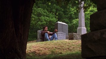 Movie still from “You Can Count on Me” (2000), directed by Kenneth Lonergan – A man sitting on the ground in front of a tombstone; Wide shot, Low angle