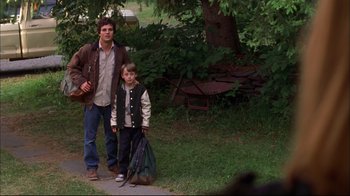 Movie still from “You Can Count on Me” (2000), directed by Kenneth Lonergan – A man and a boy walking down a sidewalk; Wide shot, Over the shoulder angle