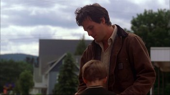 Movie still from “You Can Count on Me” (2000), directed by Kenneth Lonergan – A man and a boy standing next to each other in a yard; Medium shot, Over the shoulder angle