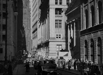 Movie still from “You Can't Take It with You” (1938), directed by Frank Capra – A black and white photo of a city street; Extreme Wide shot, High angle