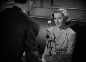 Movie still from “You Can't Take It with You” (1938), directed by Frank Capra – A man and a woman sitting on a bench; Close Up shot, High angle