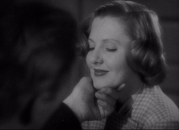 Movie still from “You Can't Take It with You” (1938), directed by Frank Capra – An old photo of a woman and a man; Close Up shot, Over the shoulder angle