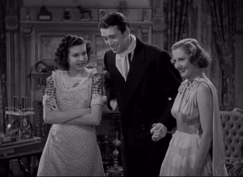 Movie still from “You Can't Take It with You” (1938), directed by Frank Capra – A man and two women standing next to each other; Medium shot, High angle