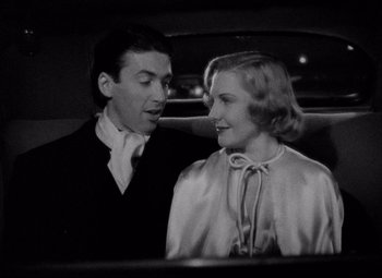 Movie still from “You Can't Take It with You” (1938), directed by Frank Capra – A man and a woman in the back seat of a car; Medium shot, Low angle
