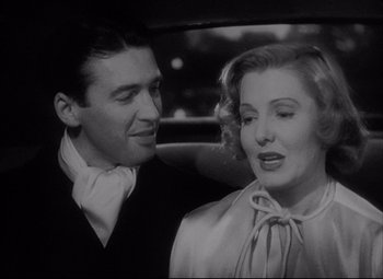 Movie still from “You Can't Take It with You” (1938), directed by Frank Capra – A man and a woman are sitting in the back of a car; Close Up shot, Low angle