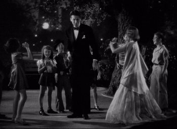 Movie still from “You Can't Take It with You” (1938), directed by Frank Capra – A group of people dancing in a park at night; Wide shot, High angle