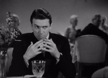 Movie still from “You Can't Take It with You” (1938), directed by Frank Capra – A black and white photo of a man sitting at a table; Close Up shot, Over the shoulder angle