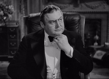 Movie still from “You Can't Take It with You” (1938), directed by Frank Capra – A man in a tuxedo sitting in a leather chair; Close Up shot, High angle