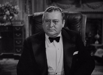 Movie still from “You Can't Take It with You” (1938), directed by Frank Capra – An older man in a tuxedo sitting in a chair; Close Up shot, Over the shoulder angle