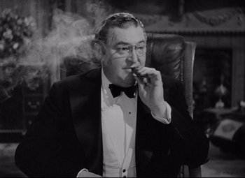 Movie still from “You Can't Take It with You” (1938), directed by Frank Capra – An older man smoking a cigarette while wearing a tuxedo; Medium shot, Low angle