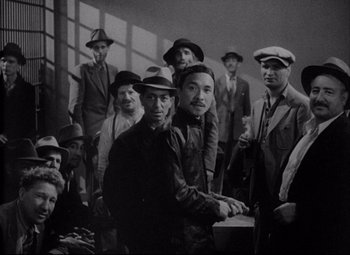 Movie still from “You Can't Take It with You” (1938), directed by Frank Capra – A group of men standing next to each other in a room; Medium shot, High angle
