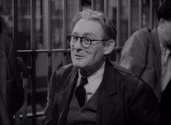 Movie still from “You Can't Take It with You” (1938), directed by Frank Capra – An older man wearing glasses and a suit; Medium shot, Low angle