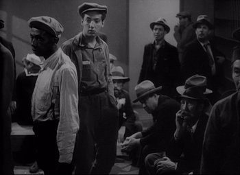Movie still from “You Can't Take It with You” (1938), directed by Frank Capra – A black and white photo of a group of men sitting on the ground; Medium shot, High angle