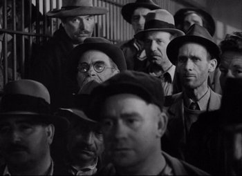 Movie still from “You Can't Take It with You” (1938), directed by Frank Capra – Black and white photograph of a group of men wearing hats; Medium shot, High angle