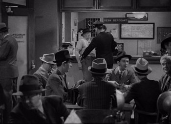 Movie still from “You Can't Take It with You” (1938), directed by Frank Capra – A black and white photo of a group of men sitting at a table; Wide shot, High angle
