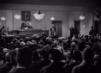 Movie still from “You Can't Take It with You” (1938), directed by Frank Capra – A crowd of people are gathered in front of a judge; Extreme Wide shot, High angle