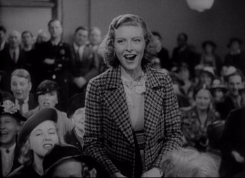 Movie still from “You Can't Take It with You” (1938), directed by Frank Capra – An old black and white photo of a woman in a crowd; Medium shot, Low angle