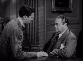 Movie still from “You Can't Take It with You” (1938), directed by Frank Capra – Two men sitting at a table in front of each other; Medium shot, Over the shoulder angle