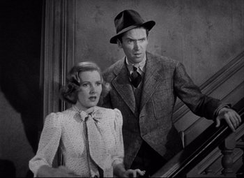 Movie still from “You Can't Take It with You” (1938), directed by Frank Capra – A man and a woman standing next to each other on stairs; Medium shot, High angle