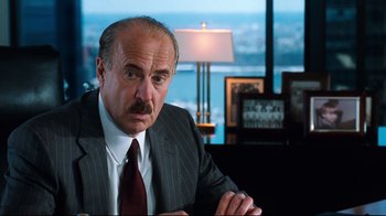 Movie still from “You've Got Mail” (1998), directed by Nora Ephron – A man in a suit and tie sitting at a desk; Close Up shot, Over the shoulder angle