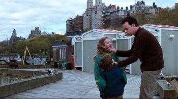 Movie still from “You've Got Mail” (1998), directed by Nora Ephron – A man is helping a girl and a boy to put lipstick on; Medium shot, Over the shoulder angle