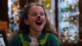 Movie still from “You've Got Mail” (1998), directed by Nora Ephron – A little girl with a cat face paint on her face; Close Up shot, High angle