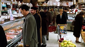 Movie still from “You've Got Mail” (1998), directed by Nora Ephron – A group of people standing in a grocery store; Wide shot, Over the shoulder angle