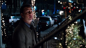 Movie still from “You've Got Mail” (1998), directed by Nora Ephron – A man standing on the side of a railing in the dark; Medium shot, Over the shoulder angle