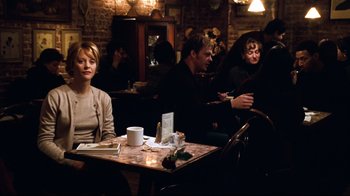 Movie still from “You've Got Mail” (1998), directed by Nora Ephron – A group of people sitting at a table in a restaurant; Medium shot, Over the shoulder angle