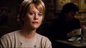 Movie still from “You've Got Mail” (1998), directed by Nora Ephron – A person with short blonde hair; Close Up shot, Over the shoulder angle
