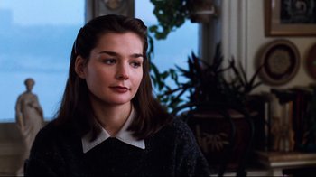 Movie still from “You've Got Mail” (1998), directed by Nora Ephron – A woman with long dark brown hair wearing a black sweater; Close Up shot, Over the shoulder angle
