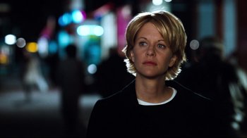 Movie still from “You've Got Mail” (1998), directed by Nora Ephron – A woman standing in the street at night; Close Up shot, Low angle