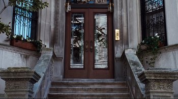 Movie still from “You've Got Mail” (1998), directed by Nora Ephron – A door that is open on the outside of a building; Wide shot, Low angle