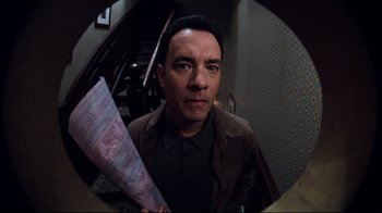 Movie still from “You've Got Mail” (1998), directed by Nora Ephron – A man is holding a bunch of money in his hand; Close Up shot, High angle