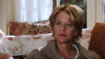 Movie still from “You've Got Mail” (1998), directed by Nora Ephron – A person sitting on a couch looking at the camera; Close Up shot, Over the shoulder angle