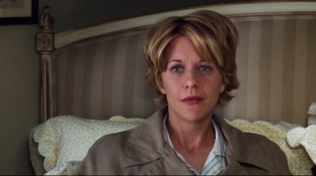Movie still from “You've Got Mail” (1998), directed by Nora Ephron – A person sitting on a bed; Close Up shot, High angle